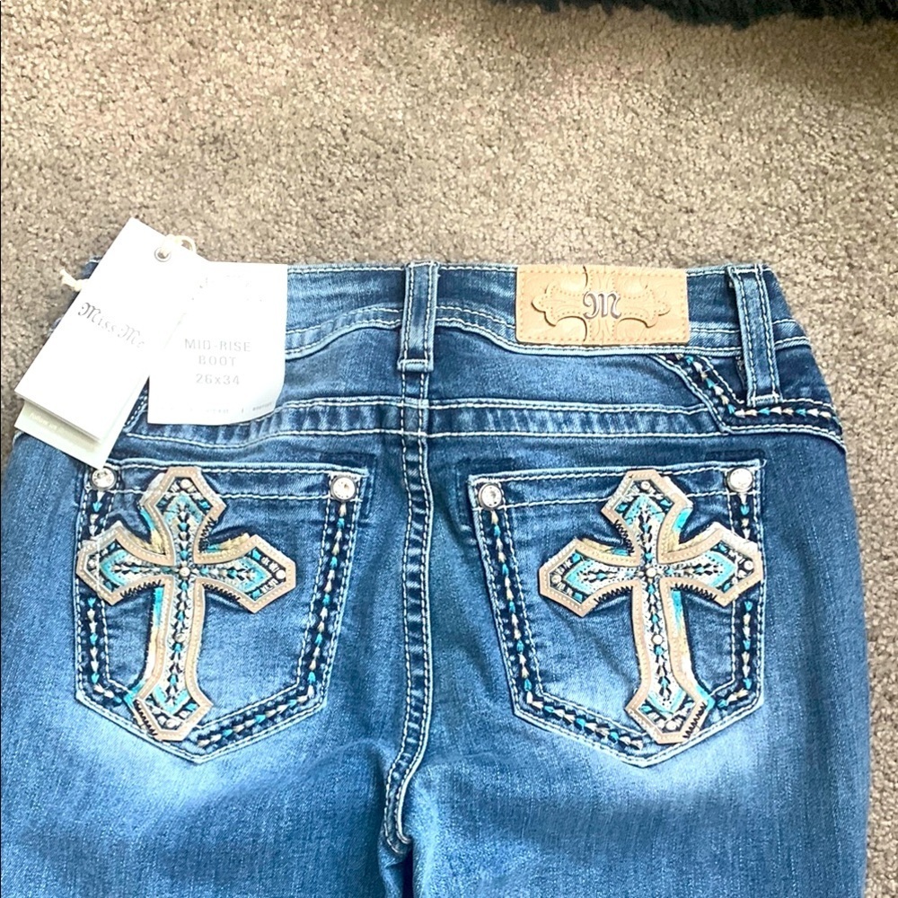 Miss Me Blue mid Rise bootcut Jeans with Ornate Cross Design